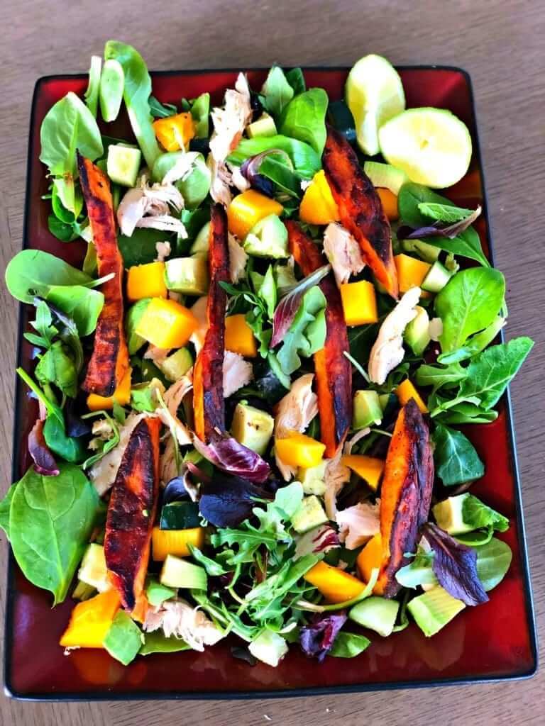 This Mango Chicken Sweet Potato Salad is an easy weeknight meal that's sure to satisfy. This dinner salad has layers of warm sweet potatoes and chicken on top of fresh, farmers market produce.