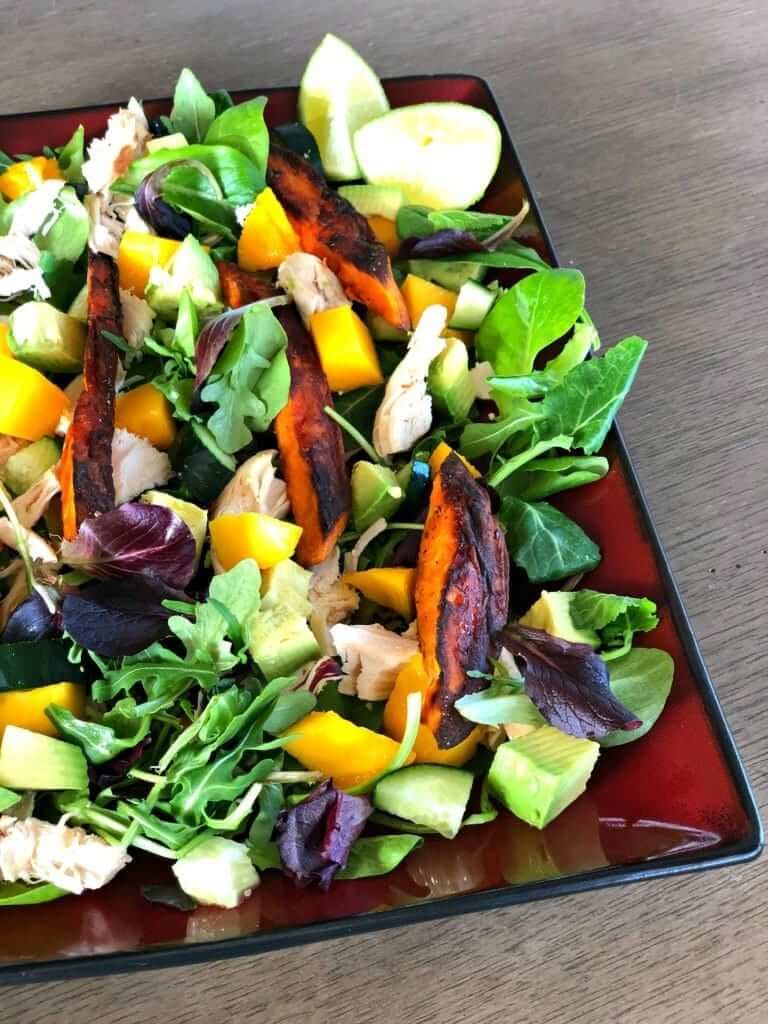 This Mango Chicken Sweet Potato Salad is an easy weeknight meal that's sure to satisfy. This dinner salad has layers of warm sweet potatoes and chicken on top of fresh, farmers market produce.