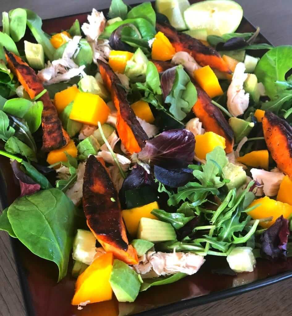 This Mango Chicken Sweet Potato Salad is an easy weeknight meal that's sure to satisfy. This dinner salad has layers of warm sweet potatoes and chicken on top of fresh, farmers market produce.